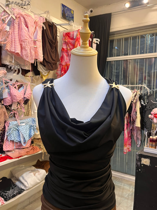 Blusa negra pliegues estrella